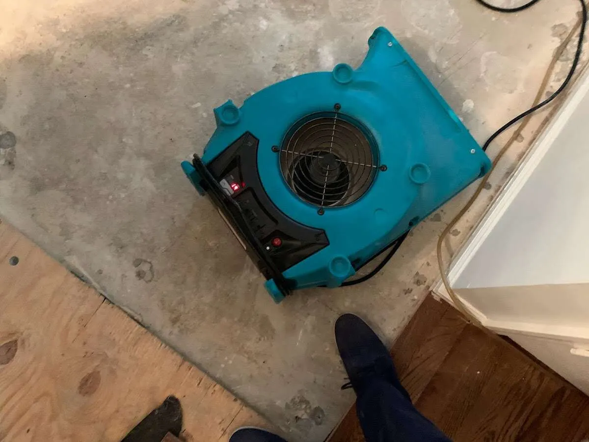 Air mover drying subfloor during Leak Detection & Repair in South Beloit